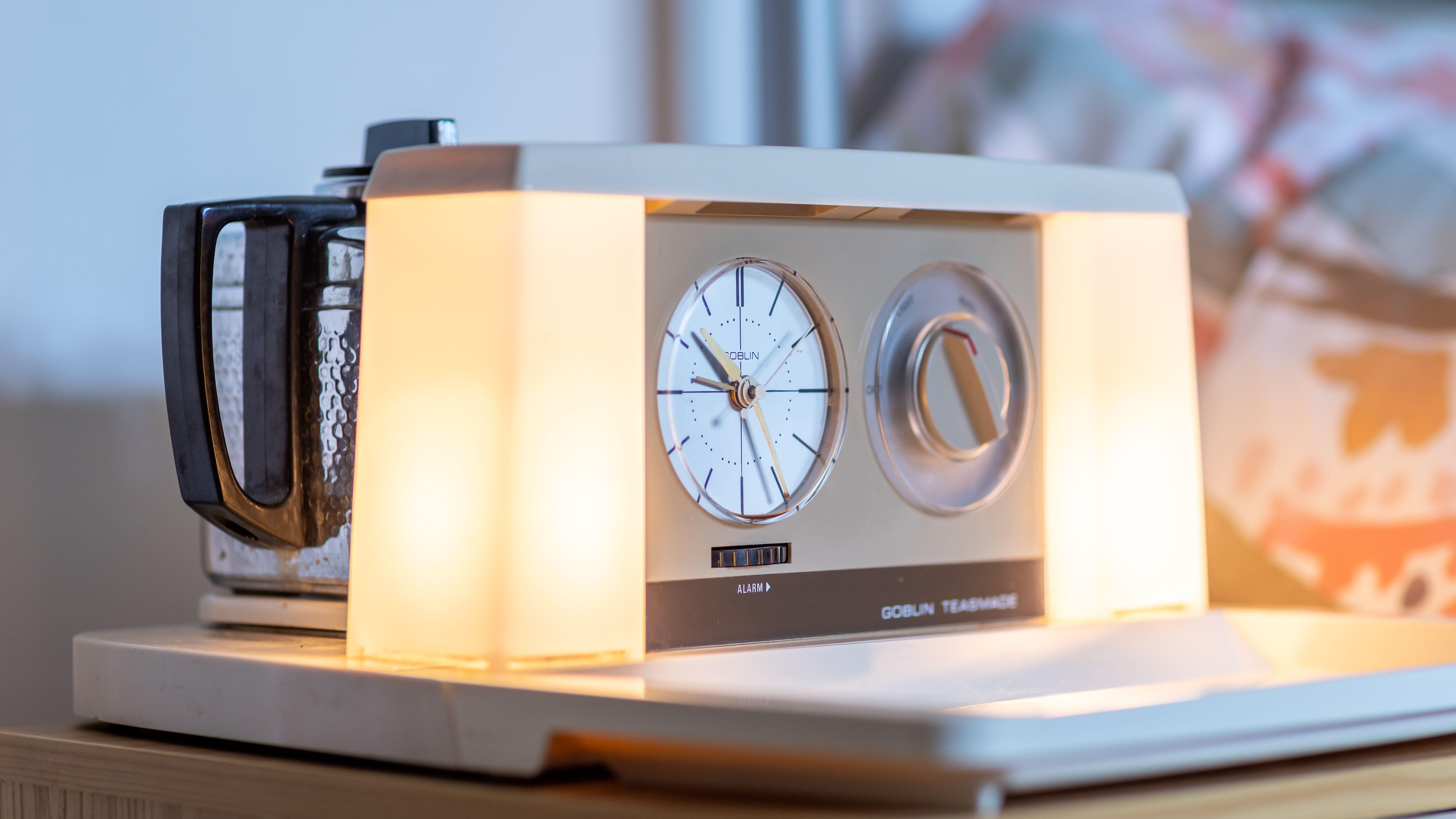 A teasmade bedside appliance with the lights switched on.
