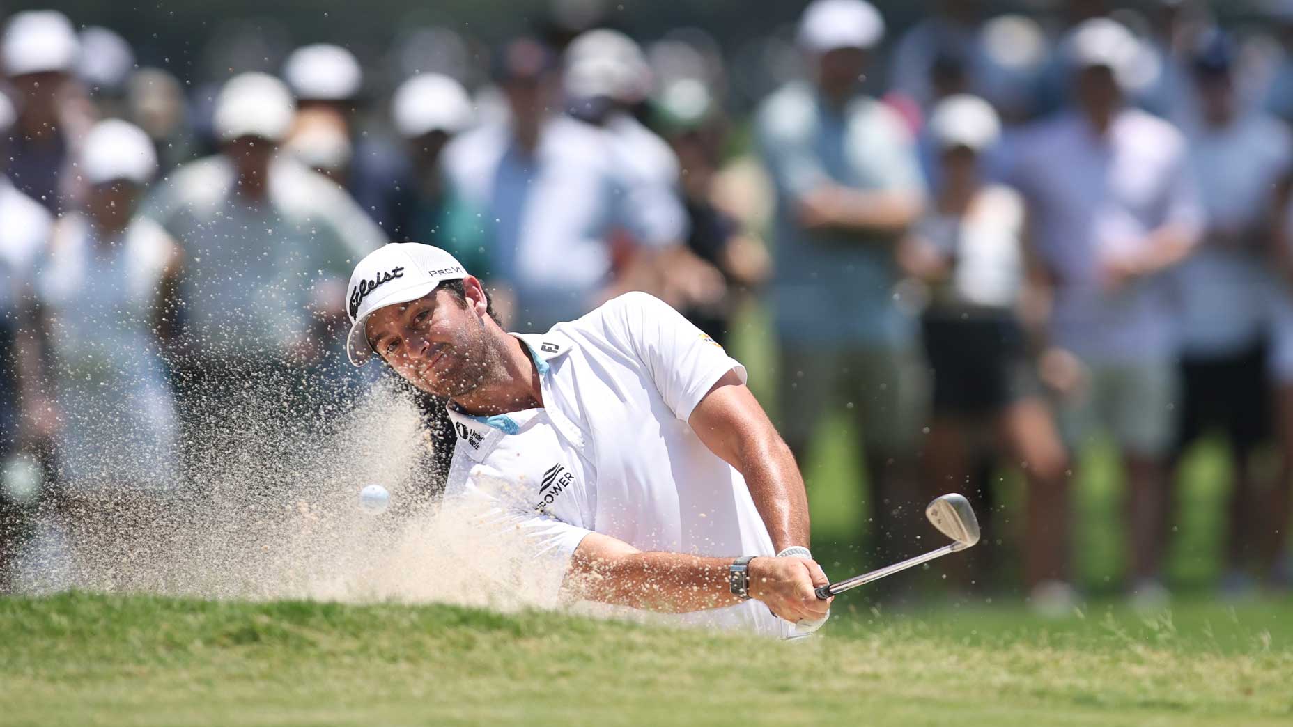 Davis Riley hits a bunker shot.