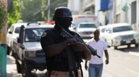 Reuters A police officer stands guard in Haiti's capital