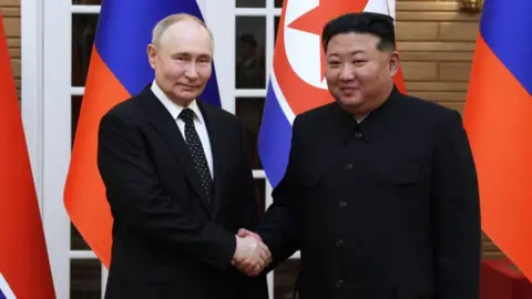 Sputnik / Getty Images In this pool photograph distributed by the Russian state agency Sputnik, North Korea's leader Kim Jong Un (R) and and Russian President Vladimir Putin shake hands after a welcoming ceremony at Kim Il Sung Square in Pyongyang on June 19, 2024