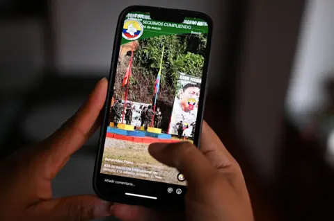 Getty An image of a hand holding a mobile phone showing a TikTok account that promotes one of the dissident armed groups in Colombia.
