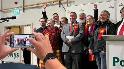 New Labour MP Steve Witherden celebrates with supporters after winning the Montgomeryshire and Glyndŵr seat