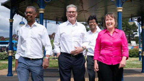 PA Labour leader Sir Keir Starmer, Vale of Glamorgan candidate Kanisha Narayan, First Minister of Wales Vaughan Gething and shadow Welsh Secretary Jo Stevens walking on Barry seafront