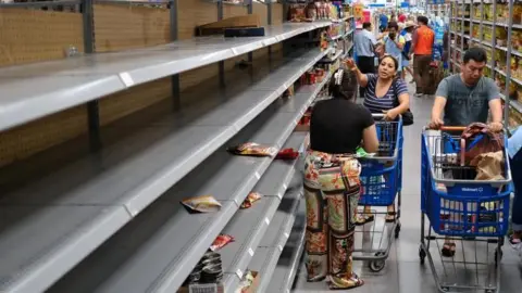 Reuters People stockpiling in a supermarket