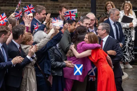 Getty Images Sir Keir Starmer and his wife greet Labour supporters as they enter Downing Street for the first time