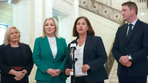 PA Media Pat Cullen, Michelle O'Neill, Mary Lou McDonald and John Finucane at the steps of the Great Hall in Stormont