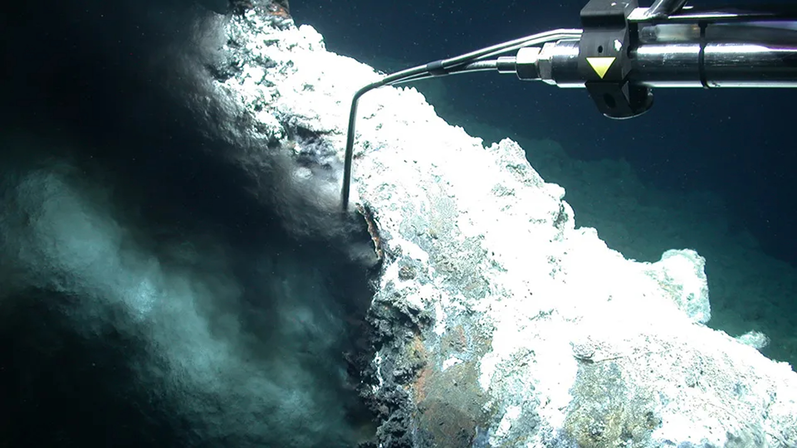 An underwater robot taking water samples for a black smoker vent