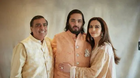 Reuters Mukesh Ambani, the Chairman of Reliance Industries, his wife Nita Ambani and their son Anant Ambani pose during the pre-wedding celebrations 