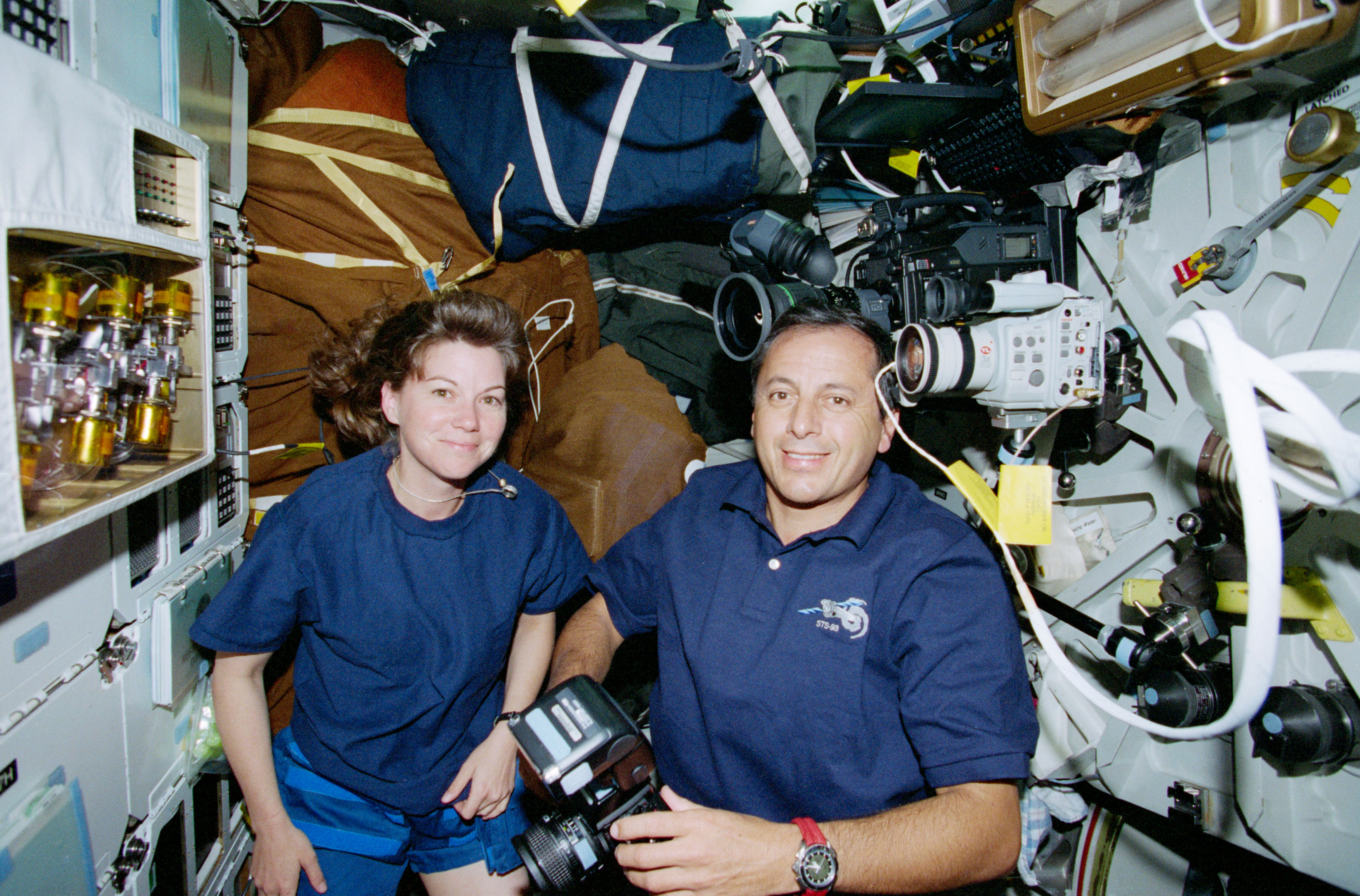 Catherine G. Coleman, left, and Michel A. Tognini pose near the Lightweight Flexible Solar Array Hinge technology demonstration experiment