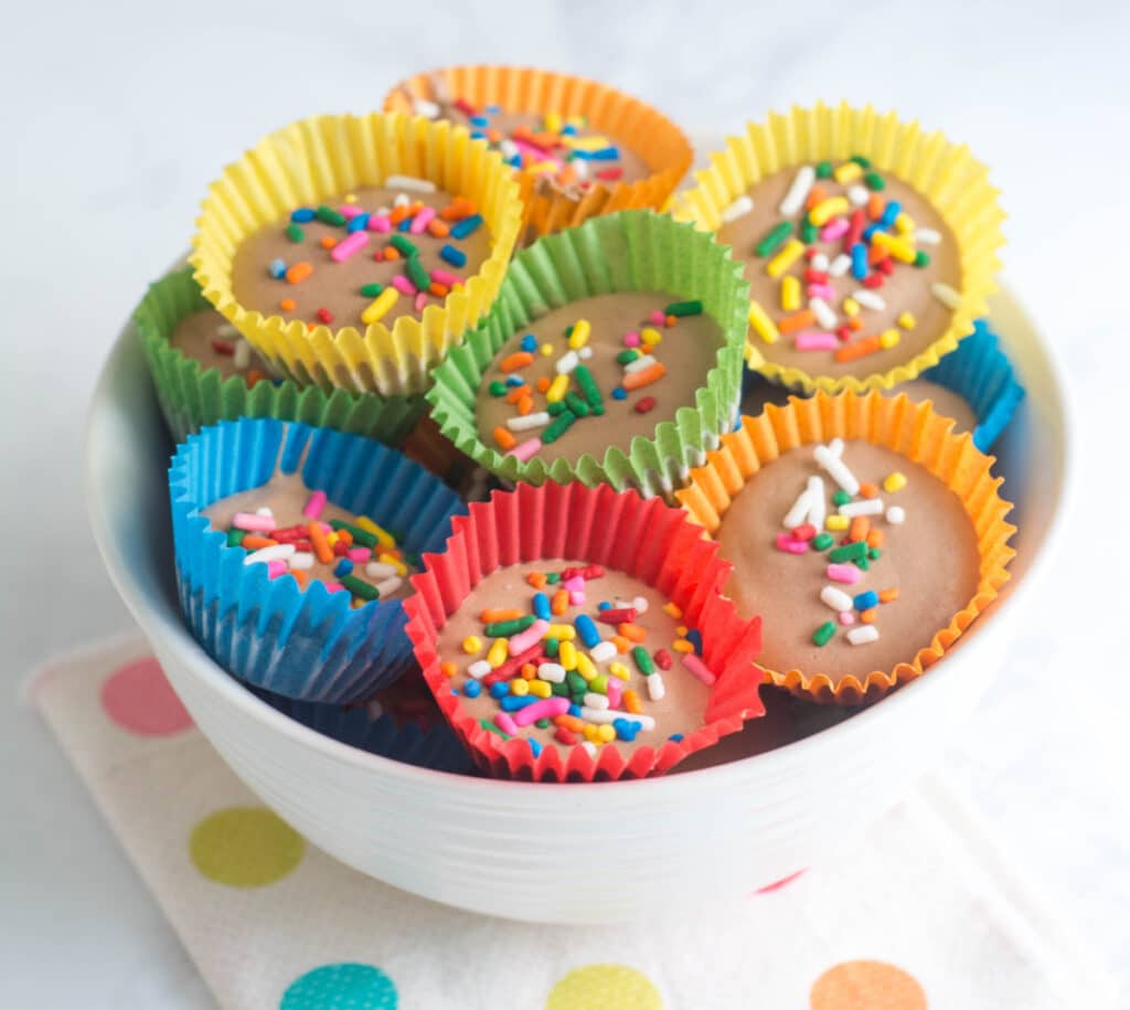 A bowl of Cottage Cheese Fudge Bites sit on a polka dot napkin on a white counter