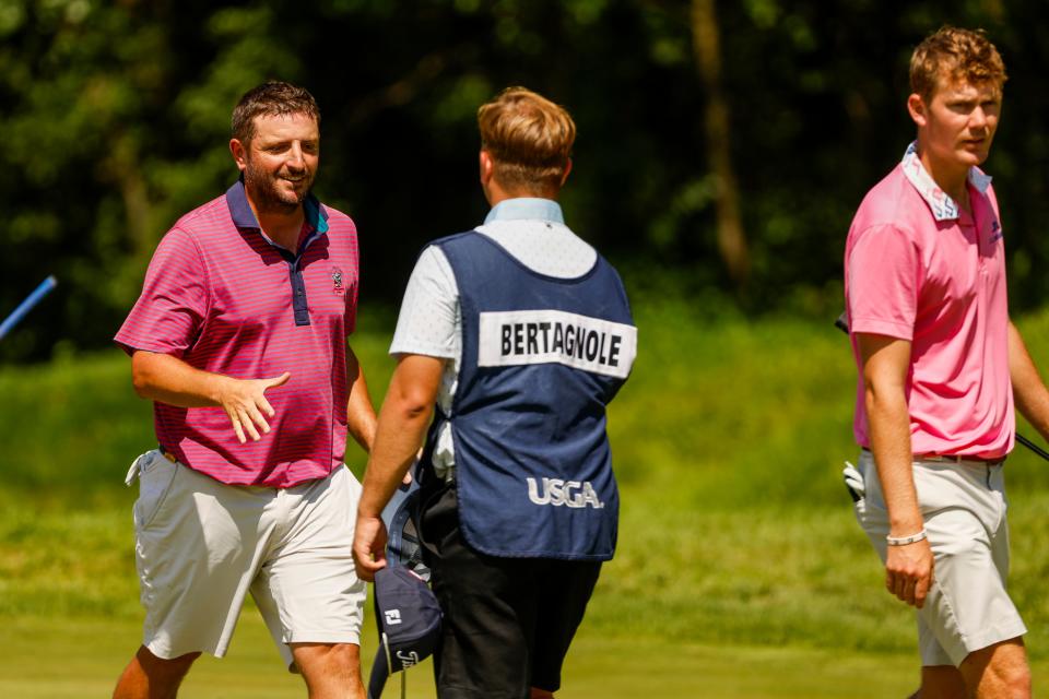 Jimmy Ellis shakes hands with competitors and their caddies after finishing the second round of stroke play on the 18th hole during the 2024 U.S. Amateur at Chaska Town Course in Chaska, Minn. on Tuesday, Aug. 13, 2024. (Chris Keane/USGA)