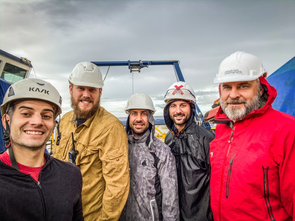 A selfie of the filmmaker of Our Alien Earth, Mike Toillion, with members of the glider team wearing hard hats.