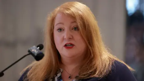 PA Media Naomi Long speaking into microphone 