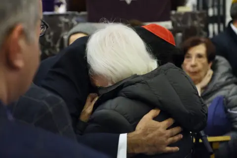 PA Media Humza Yousaf and Bernard Cowan's mother during his solidarity service