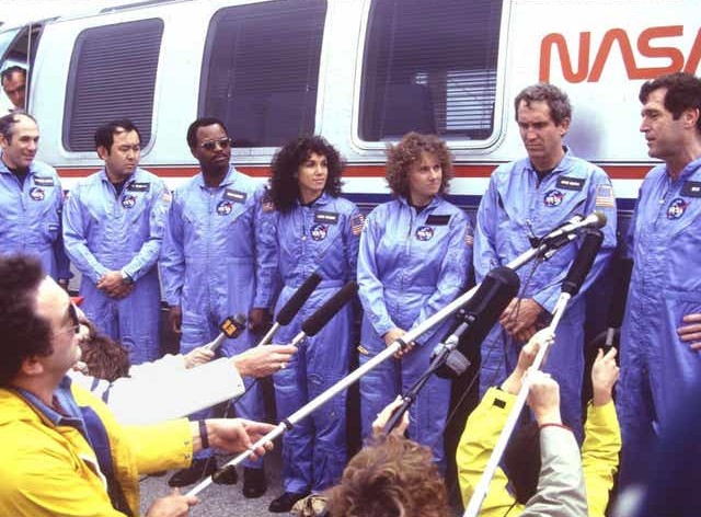 The STS-51L crew answer reporters’ questions following the Terminal Countdown Demonstration Test (TCDT)