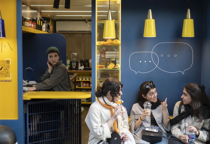 Women talk at a café in Tehran during the election campaign in June