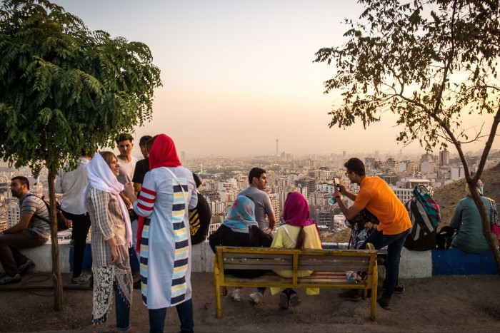 Crowds view the city skyline from a terrace in Tehran