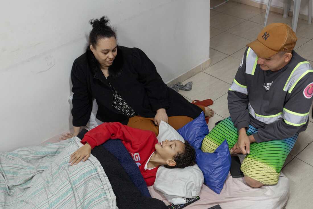 SÃO PAULO, SP, BRAZIL - AUG 13, 2024: Erica Lacerda de Souza, her son Henrique and her husband Bruce Lee de Souza, relax in their new home in Guaianazes, São Paulo.