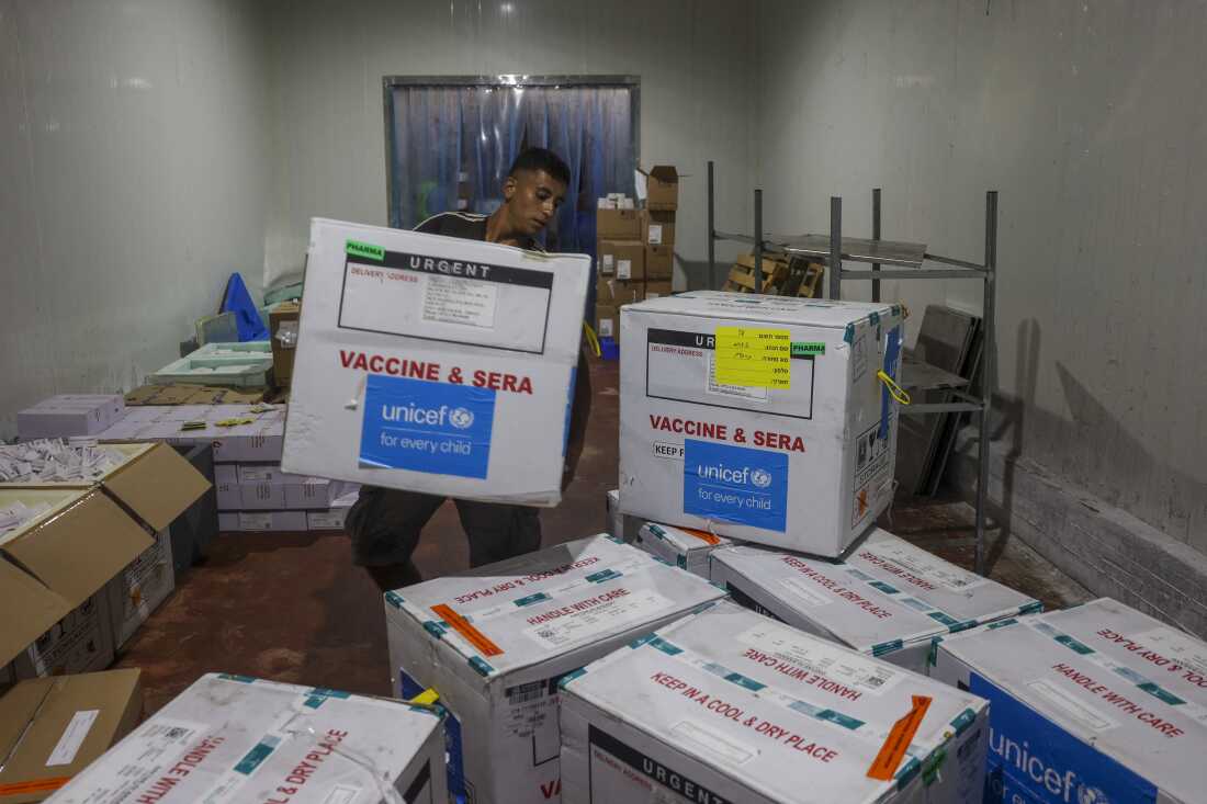 A worker unloads a shipment of polio vaccines provided with support from UNICEF to the Gaza Strip through the Karm Abu Salem crossing, also known as Kerem Shalom, at a depot belonging to Gaza's health ministry on Aug. 25.