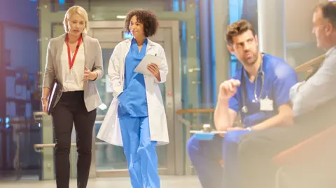 Getty Images Hospital corridor with doctors talking