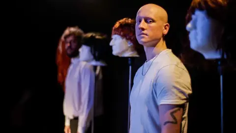 Caden Elliott Actor and playright Sam McGregor poses on stage at a theatre in Northumberland ahead of performing his show Truly Madly Baldy