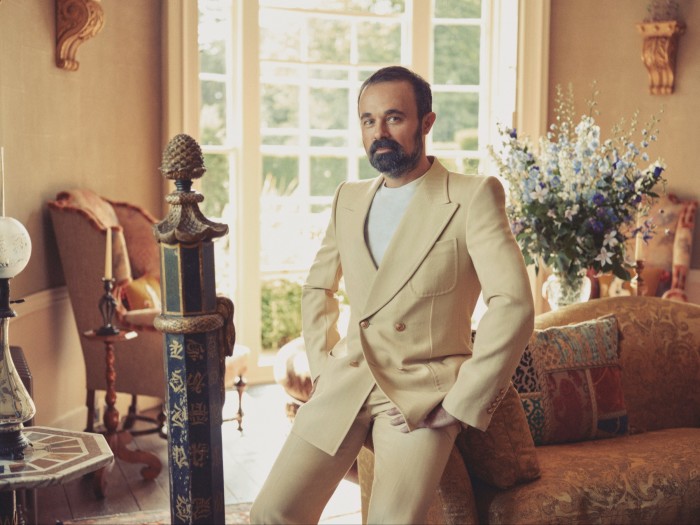 Lebedev leans on a George III-style sofa in the reception room