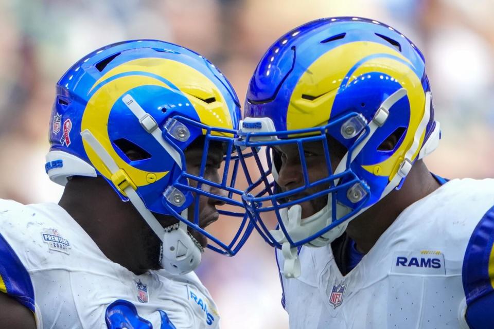 Rams defensive tackles Kobie Turner (left) and Aaron Donald celebrate last season.