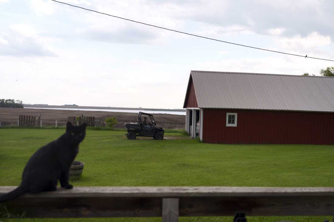 Cindie Haakenson drives an ATV out of her garage in Willow City, N.D., on May 21.