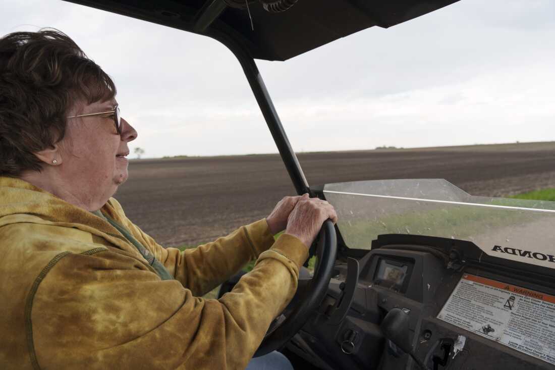 Cindie Haakenson drives an ATV between her family farm and a neighboring property in Willow City, N.D. on May 21.