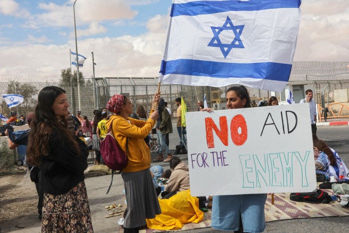 Demonstrators gather by the border fence with Egypt this year, as they attempt to block humanitarian aid trucks from entering Israel on their way to the Gaza Strip