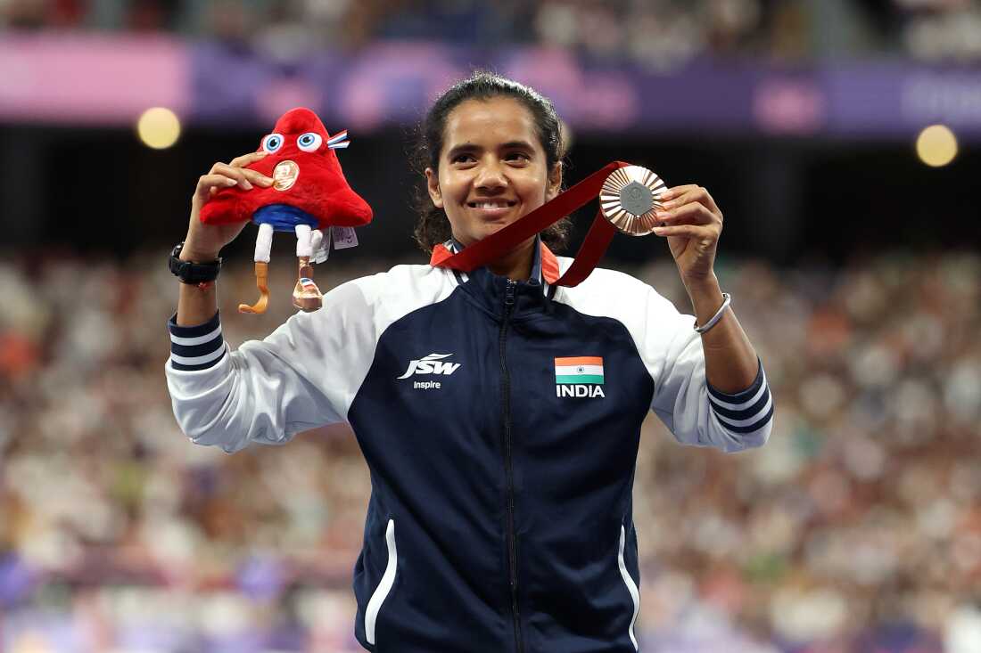 PARIS, FRANCE - SEPTEMBER 01: Bronze medalist Preeti Pal of Team India celebrates on the podium at the Para Athletics Women's 200m - T35 Medal Ceremony on day Four of the Paris 2024 Summer Paralympic Games at Stade de France on September 01, 2024 in Paris, France. (Photo by Tasos Katopodis /Getty Images)