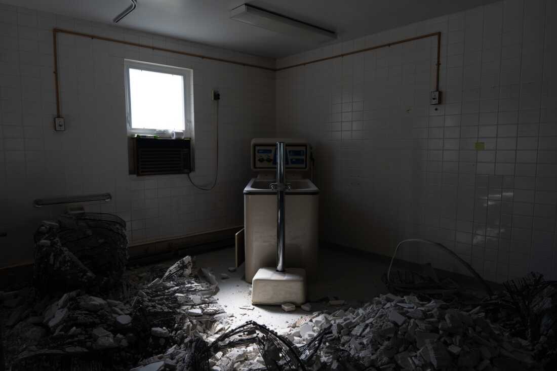 Demolished walls surround a bathtub at a recently shuttered nursing home in Armour, S.D., on May 29. The facility, which operated as the only nursing home in town for many years, closed after sustained staffing and financial pressures. 