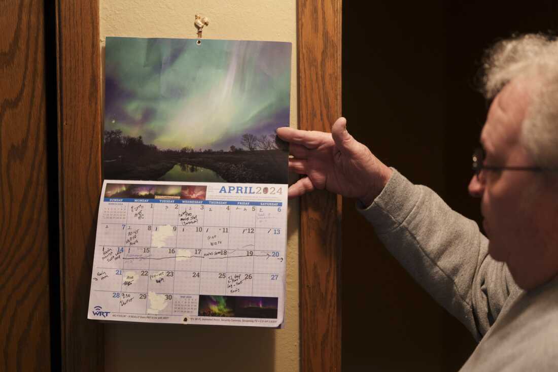 Randy Anderson flips through a calendar filled with medical appointments at his home in Turtle Lake, N.D., on May 22. Randy and his wife Marlys, who both deal with various health concerns, find their regular trips to Bismarck for care to be a considerable burden. “It’s like a full-time job almost,” Anderson said.