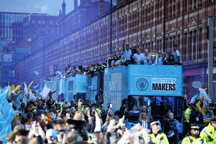 Manchester City team bus during a trophy parade in Manchester