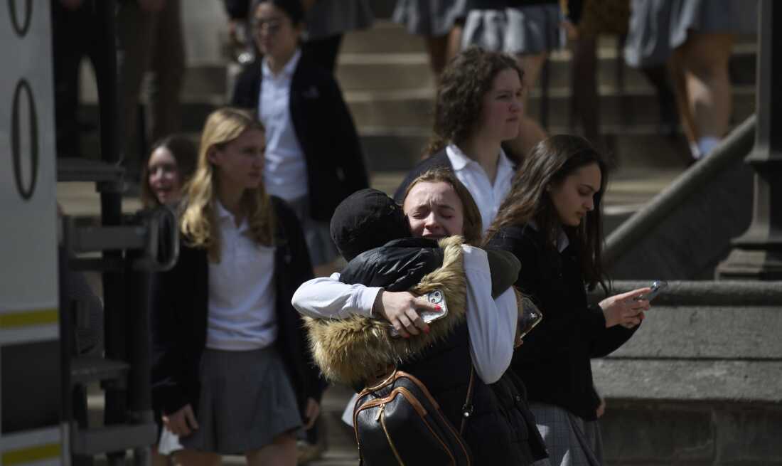 A student from Oakland Catholic High School receives comfort following a school evacuation prompted by a computer-generated swatting call about an active shooter on campus. 