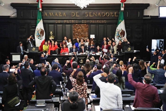 Members of Mexico’s Senate celebrate after they passed the controversial judicial reform at the Senate’s chamber in Mexico City on September 11