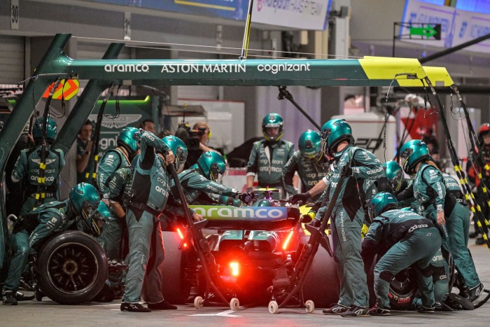 Mechanics work on the car of Aston Martin’s Spanish driver Fernando Alonso at the Singapore Grand Prix last year