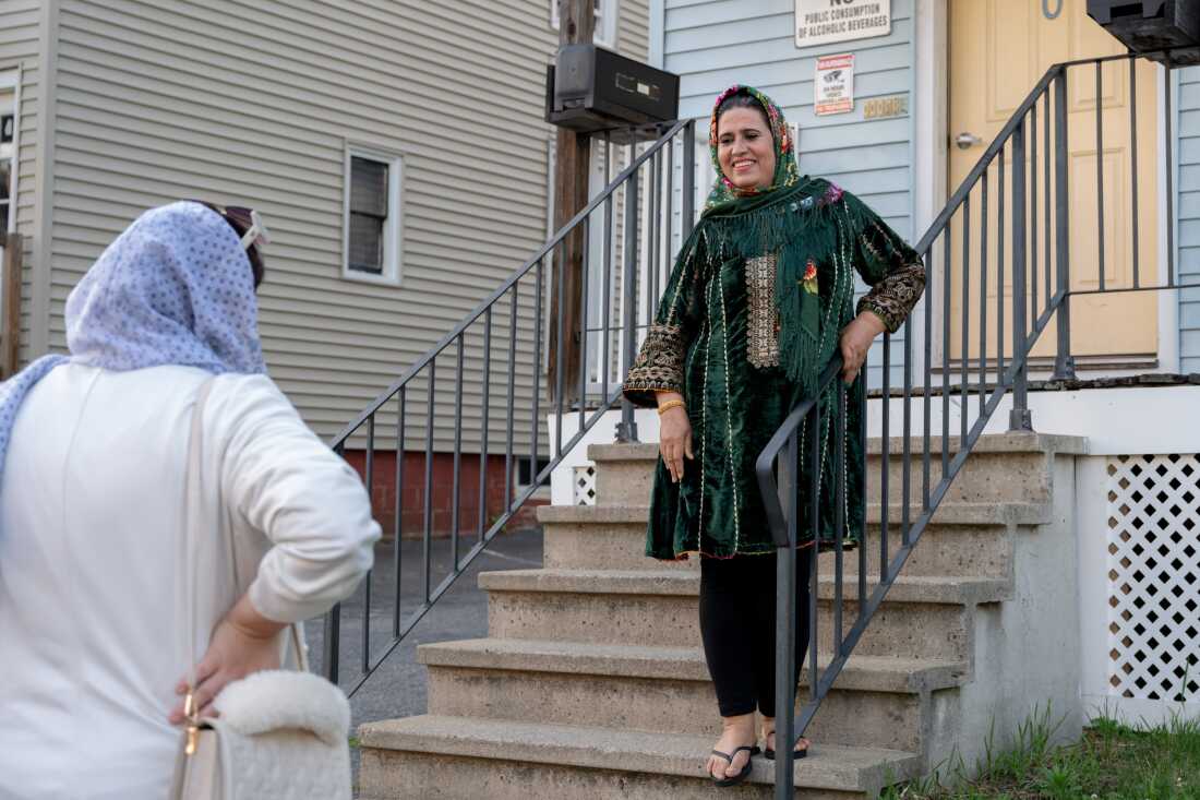 Khadija Rahmani speaks with Shabana Siddiqui, left, as she leaves the Rahmani’s home in Lewiston, Maine.