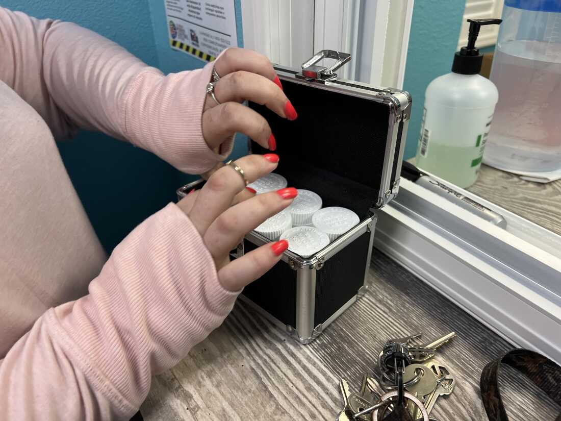 Stephanie puts a week's worth of methadone doses directly into a lockbox, in accordance to facility pick-up rules. She travels almost an hour to reach the nonprofit clinic in Inverness, Fl. and relies on Medicaid coverage to pay for the treatment.