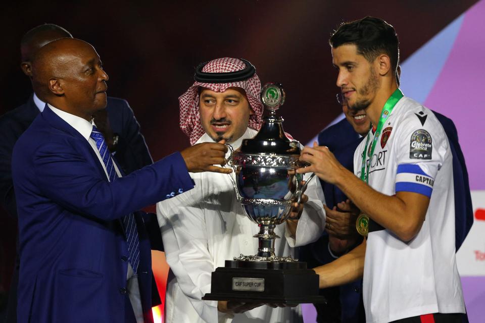 Caf president Patrice Motsepe presents the Super Cup trophy to USM Alger captain Zineddine Belaid in Riyadh in September 2023. 