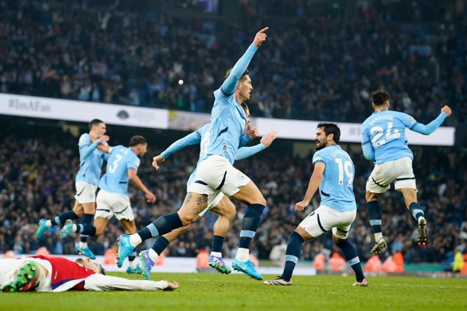 John Stones celebrates after firing home Manchester City’s equaliser (AP)