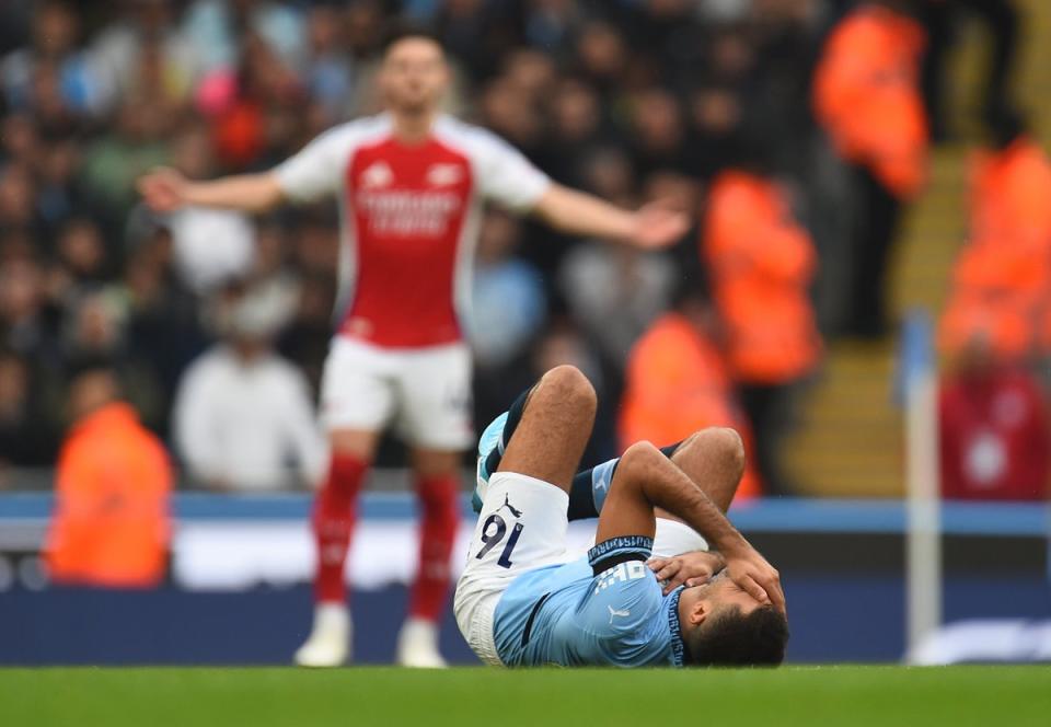 Rodri goes down with a concerning injury against Arsenal (EPA)