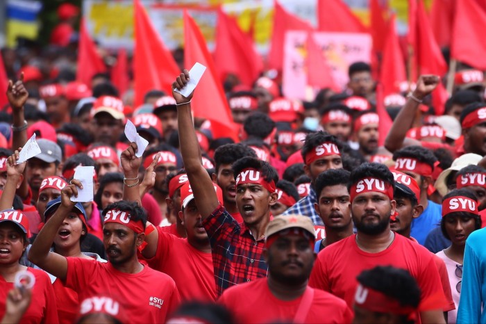 JVP supportersin red shirts with headbands of the party’s Socialist Youth Union