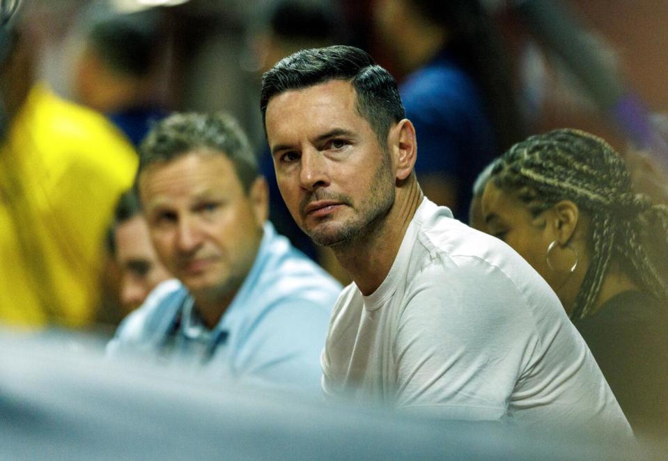 Lakers coach JJ Redick sits courtside during Summer League game in Las Vegas.