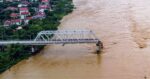 Flooding sweeps away a bus and a bridge collapses in Vietnam as storm deaths rise to 59