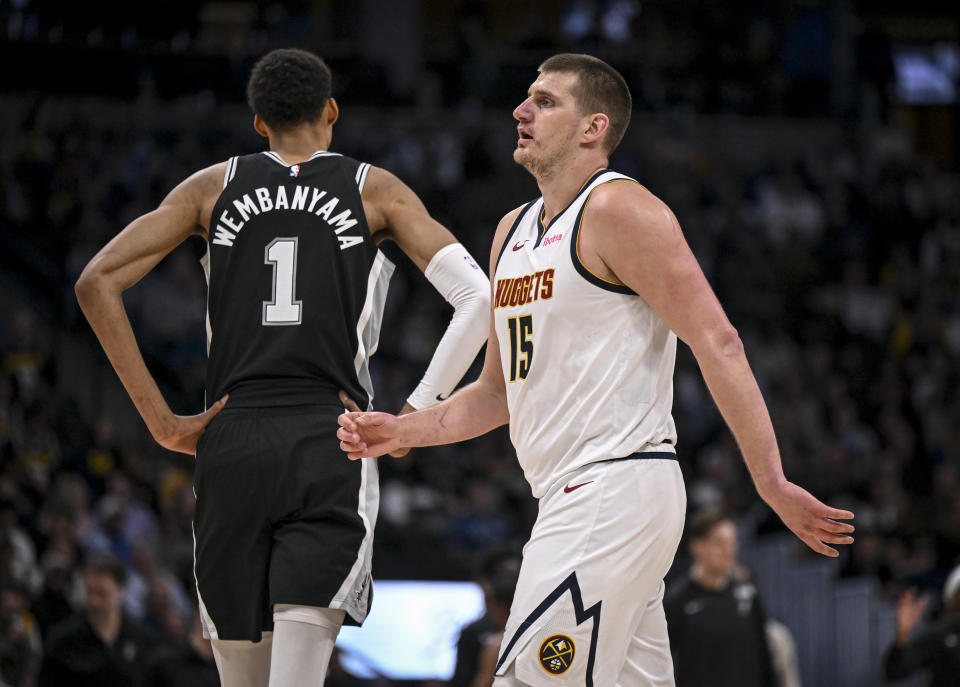 DENVER, CO - APRIL 2: Nikola Jokic (15) of the Denver Nuggets and Victor Wembanyama (1) of the San Antonio Spurs