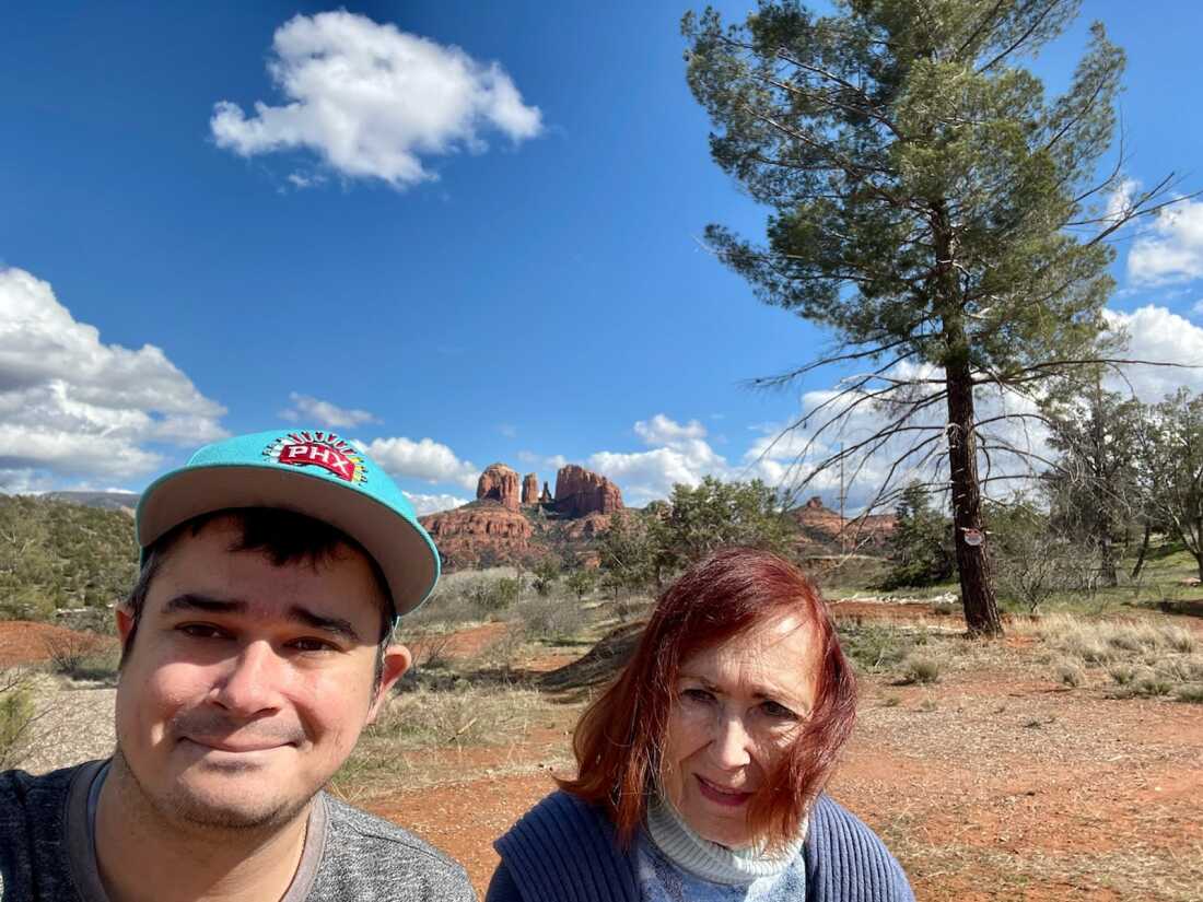 Ravi had moved to Arizona, hoping for a fresh start. Here, he is with his mother, Barbara Webber. He is a young man with dark hair; his mother is older and has red hair. They are standing in a beautiful desert landscape.