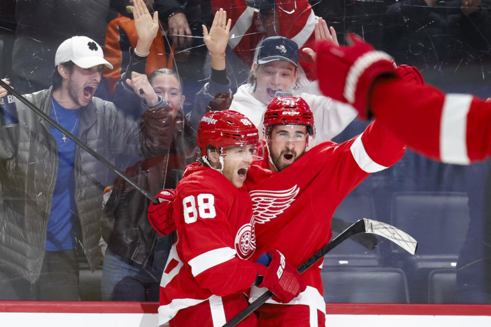 Feb 22, 2024; Detroit, Michigan, USA; Detroit Red Wings right wing Patrick Kane (88) receives congratulations from center Dylan Larkin (71) after scoring in overtime against the Colorado Avalanche at Little Caesars Arena