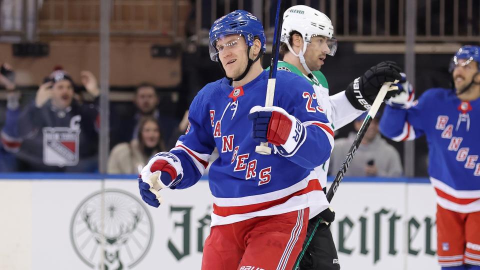 New York Rangers defenseman Adam Fox (23) celebrates his goal against the Dallas Stars in front of Stars center Craig Smith (15) during the first period at Madison Square Garden.