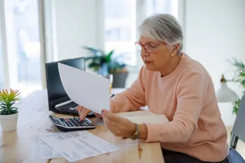 Getty Images Elderly person with an energy bill